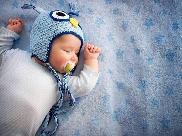A 2-month old baby sleeps comfortably.