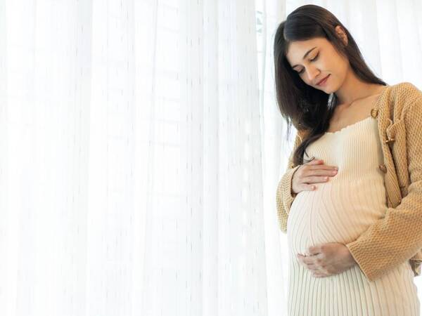 A pregnant woman contemplates creating a birth plan to document her wishes for labor and delivery.