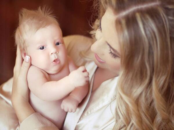 A mother holds her infant.