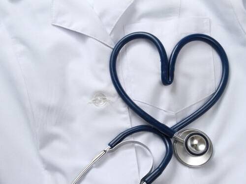 Stethoscope on top of white lab coat, symbolizing heart health.