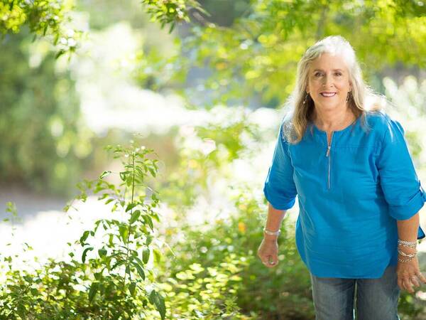 Knee replacement patient Lynn Sago takes a walk.