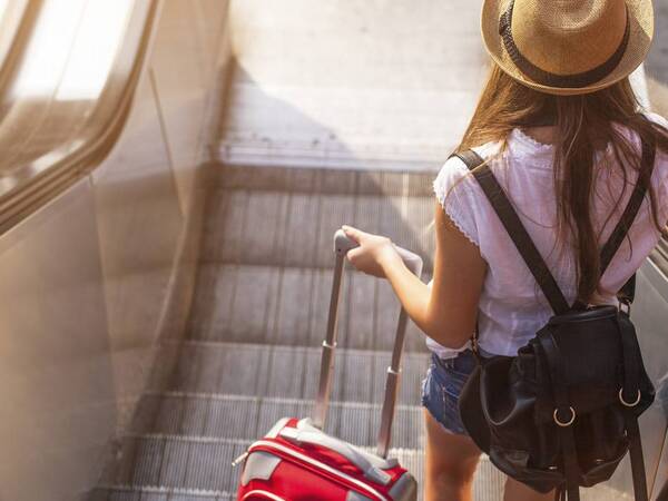 A suitcase is packed and ready to accompany a young traveler on her fun, safe and healthy vacation.