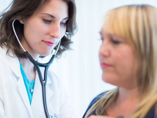 A Scripps HealthExpress walk-in clinic provider works on a patient.