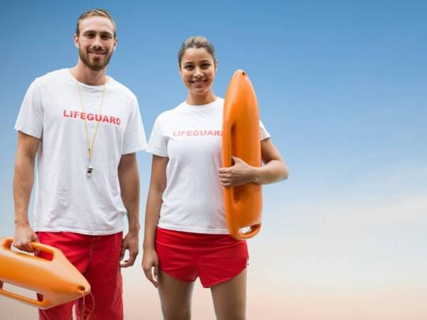Two lifeguards look on before getting screened for skin cancer by Scripps physicians. 