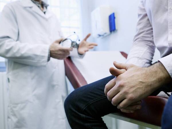 A prostate cancer patient discusses his condition with his oncologist.