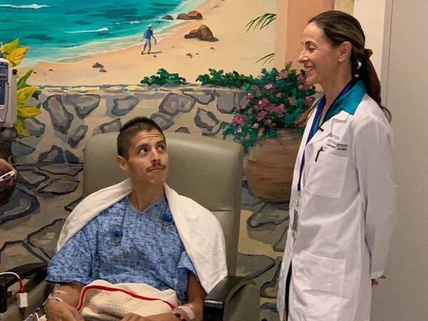 William Apodaca, who has a rare form of cancer, was treated at Scripps Mercy Hospital with a new cancer therapy. Seen in picture with his oncologist, Dr. Marin Xavier.
