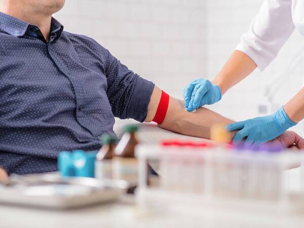 A man donating blood illustrates the importance of donating blood during the holiday season.