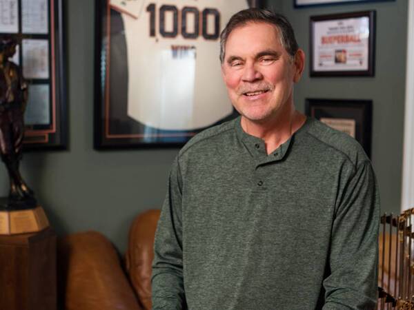 Bruce Bochy, former San Diego Padres manager, smiles and holds his wife’s hand, grateful to be free from atrial fibrillation after treatment at Scripps.
