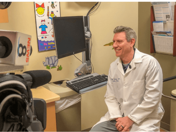 Mark Shalauta, MD, a family medicine physician at Scripps Clinic, discussing measles outbreak with a local TV reporter.