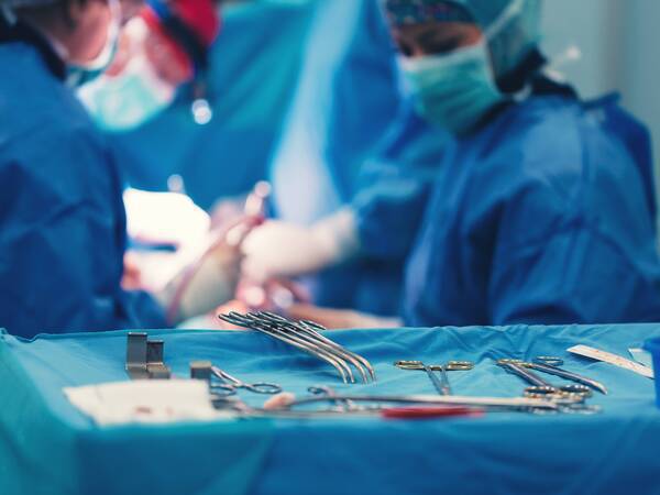 Surgical team performing heart surgery in operating room.