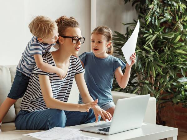 Busy mom trying to work and take care of her kids.