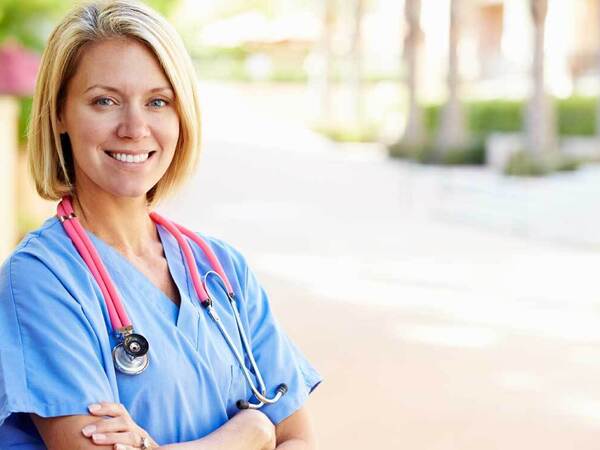 A professional nurse smiles to greet prospective nurses and RNs attending a Scripps Health Open House hiring event. 