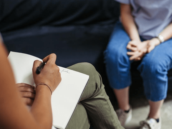 Clinician speaks to a behavioral health patient.