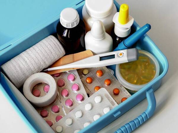 A medicine box is filled with the essentials including cold and flu medicines, thermometer and bandages. As seen in San Diego Health Magazine
