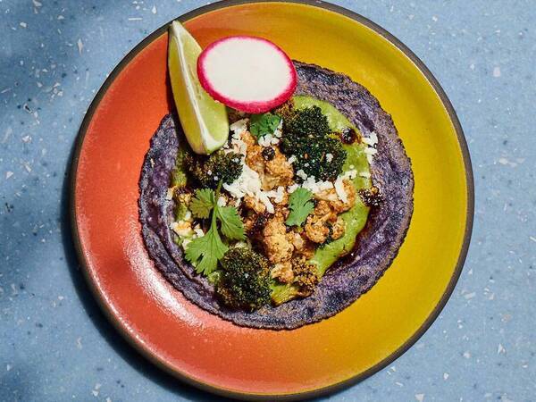 Puesto's Scripps-inspired healthy plant-based taco with roasted cauliflower and broccoli, a spicy, veggie-forward mole verde, panela cheese and cilantro. San Diego Health Magazine