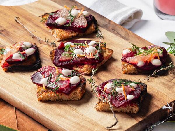 This light bites appetizer features roasted beets on sourdough with truffle cream.