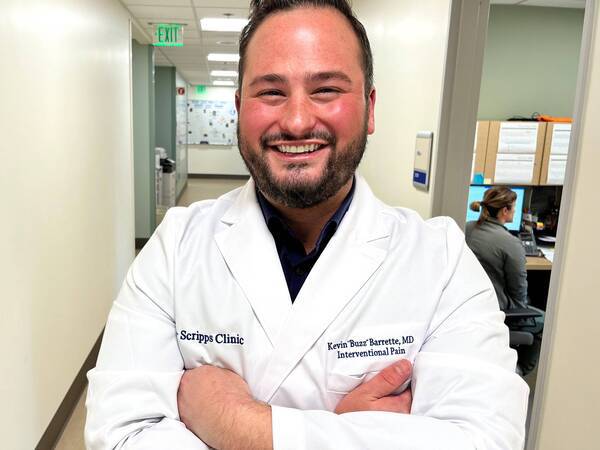 Dr. Kevin Barrette a Pain Management physician, smiling in the clinical setting.