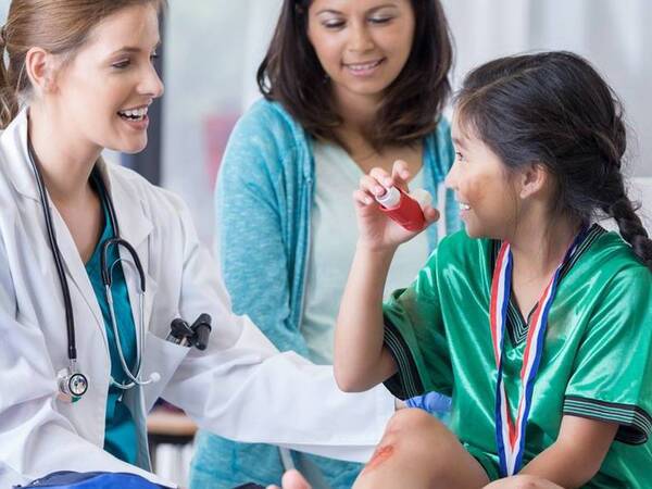 A mom and her young daughter go the doctor after a soccer injury.