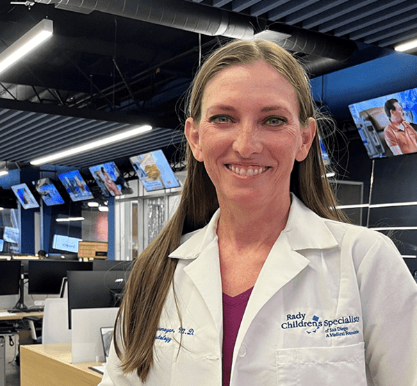 Dr. Casey Cohenmeyer, Rady Children's Hospital in the room where there are many televisions behind her.