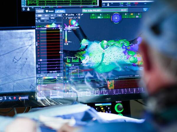 A cardiac electrophysiologist looks at advanced images of the heart in atrial fibrillation treatment.