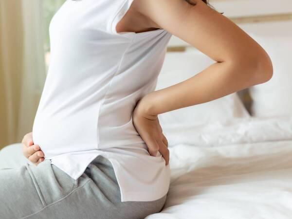 A pregnant woman experiences discomfort.