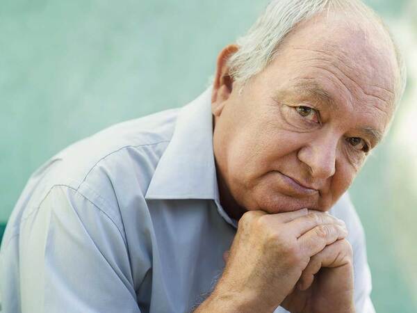A serious mature man represents the power and value of knowing lung cancer symptoms.