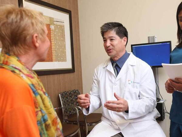 A smiling doctor, nurse and patient represent the importance of skin cancer screening and prevention.