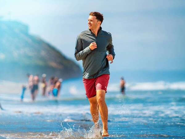 Kenny Lopez runs on the beach after recovering from back surgery.