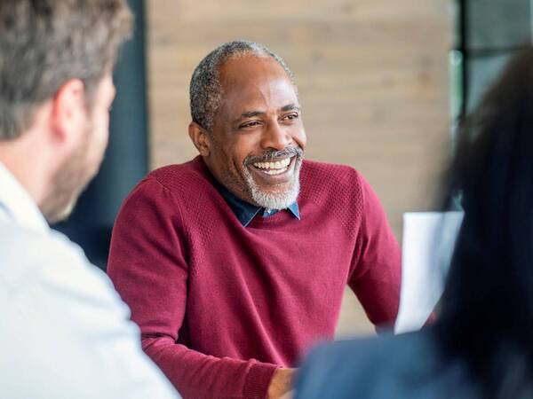 An older African-American man discussing symptoms of male menopause, which is another name for low-testosterone.