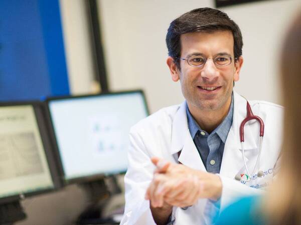 Dr. Plodkowski discusses weight management with a patient.