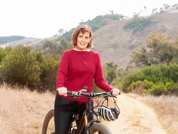 Whitney on her mountain boke ready to go on a bike ride.