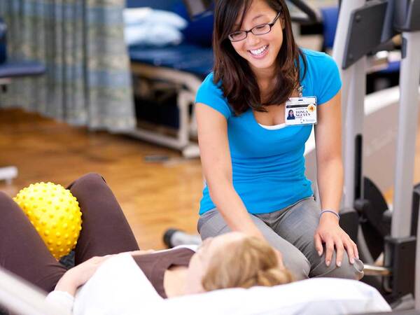 Scripps pelvic floor physical rehabilitation therapist assists a patient in a therapy treatment. 