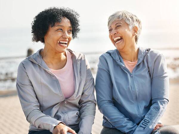 Two senior women laugh outdoors representing the expert stroke care at Scripps.