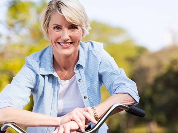 A smiling mature woman represents the full life that can be led after endometrial cancer treatment.