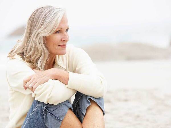 A smiling mature woman represents the full life that can be led after ovarian cancer treatment.