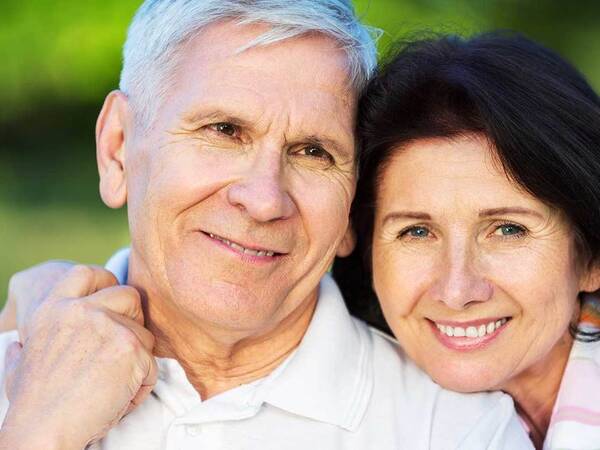 A smiling mature couple represents the full life that can be led after esophageal cancer treatment.