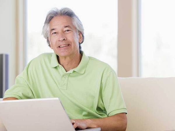 A smiling middle-aged Asian man represents the full life that can be led after nasopharyngeal cancer treatment.