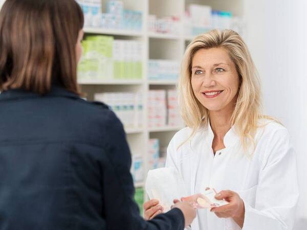 Pharmacist consulting patient about medication