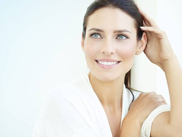 A beautiful young woman, representing the confidence you can gain after cosmetic skin treatments.